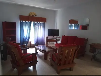 a living room with red chairs and a table at Casa en Las Tapias cerca de Villa de Las Rosas in San Javier