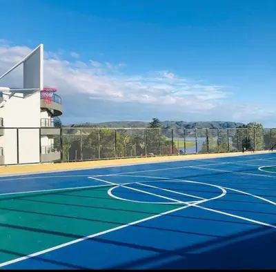a tennis court with a blue court at Departamento con vista al lago en Veneto Village in Villa Parque Siquiman