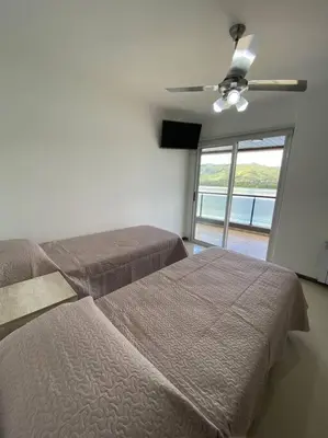 a bedroom with two beds and a ceiling fan at Departamento con vista al lago en Veneto Village in Villa Parque Siquiman