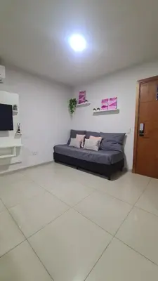 a living room with a couch in a white room at Opera Villa Carlos Paz- Moderno - exclusivo- La mejor ubicación in Villa Carlos Paz