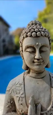 a stone statue of a buddha with eyes closed at La casita in Villa General Belgrano