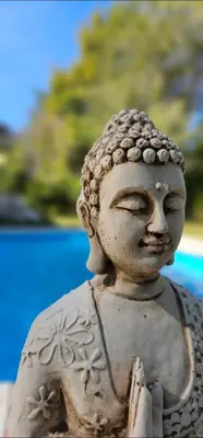 a stone statue of a buddha with eyes closed at La casita in Villa General Belgrano
