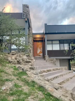 a house with stairs in front of a building at Casa de campo in Villa San Nicolás