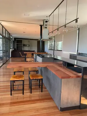 a kitchen with two stools and a counter with a bar at Casa de campo in Villa San Nicolás