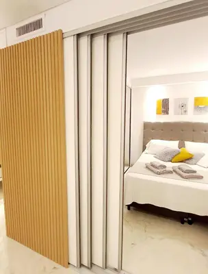 a bedroom with a bed and a sliding glass door at Dpto Temporario Córdoba, ubicación ideal in Cordoba