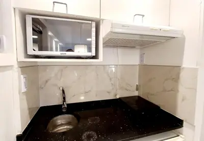 a kitchen with a sink and a microwave at Dpto Temporario Córdoba, ubicación ideal in Cordoba