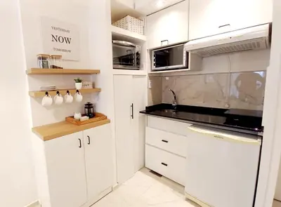 a kitchen with white cabinets and a sink at Dpto Temporario Córdoba, ubicación ideal in Cordoba