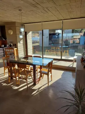 a dining room with a blue table and chairs at SARA HOUSE LARGE in Santa Rosa de Calamuchita