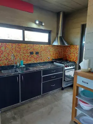 a kitchen with a stove and a sink at SARA HOUSE LARGE in Santa Rosa de Calamuchita