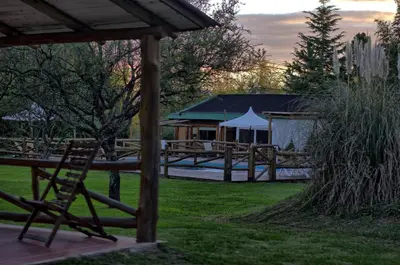 a yard with a picnic table and a gazebo at Cabañas Cuatro Horizontes in Villa General Belgrano