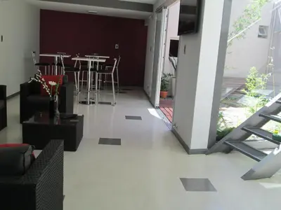 a living room with a table and chairs at Cañas Suites Urbanas in Mina Clavero