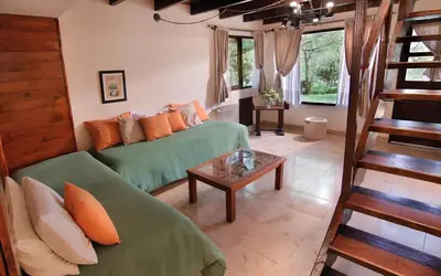 a living room with a couch and a table at Aldea de los Pajaros in Villa General Belgrano