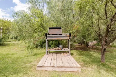 a piano sitting on a wooden platform in a field at Cabañas con jacuzzi privado y vistas al cerro Champaquí in San Javier