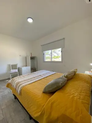 a bedroom with a large bed with pillows on it at Casa del Valle Merlo in Merlo