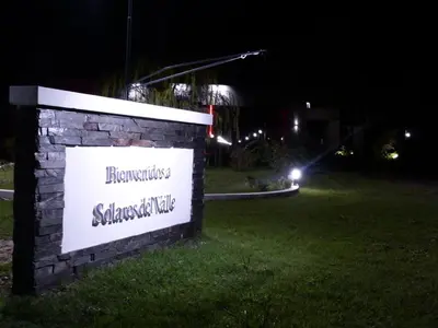 a sign in the grass in a yard at night at Casa del Valle Merlo in Merlo
