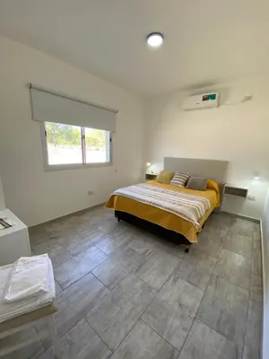 a bedroom with a bed and a window in it at Casa del Valle Merlo in Merlo
