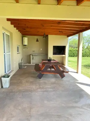 a large patio with a table in the middle at Casa del Valle Merlo in Merlo