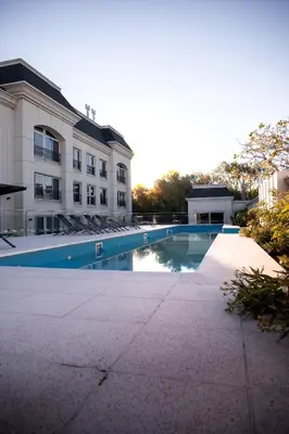 a swimming pool in front of a building at Apart France - Con Gim, Piscina y estacionamiento - Matrimonial in Río Cuarto