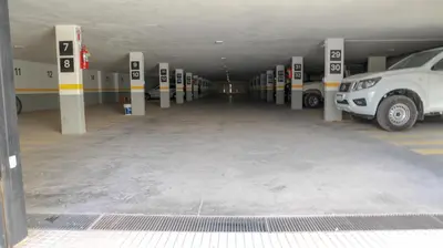 a parking lot with cars parked in a parking garage at Apart France - Con Gim, Piscina y estacionamiento - Matrimonial in Río Cuarto