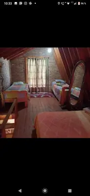 a room with two beds and a brick wall at Lo de chave in Villa Rumipal