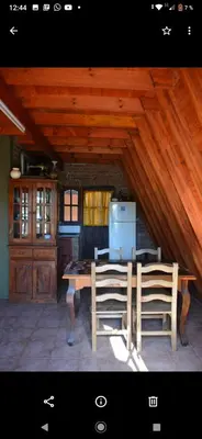 a kitchen with a table and chairs and a refrigerator at Lo de chave in Villa Rumipal