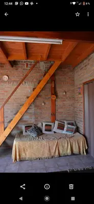 a room with a bed in a brick wall at Lo de chave in Villa Rumipal