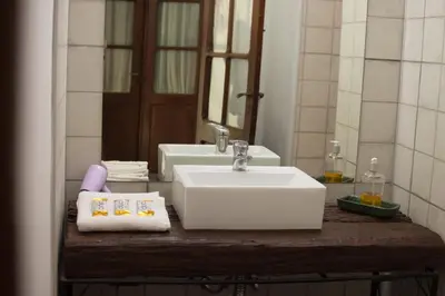 a bathroom with a white sink and a mirror at Luna de Alberdi Apart in Cordoba