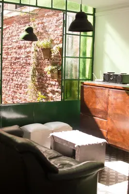 a living room with a couch and a dresser at Luna de Alberdi Apart in Cordoba