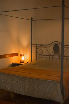 a bedroom with a bed with a metal canopy at Luna de Alberdi Apart in Cordoba