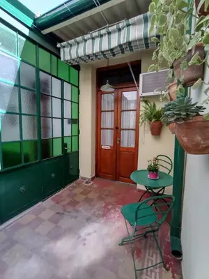 a room with a door and a table and chairs at Luna de Alberdi Apart in Cordoba