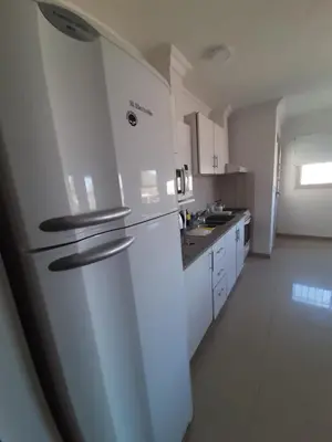 a white kitchen with a refrigerator and a sink at ALTOS DE VILLA CABRERA in Cordoba