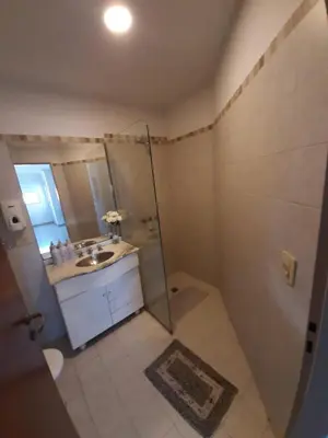 a bathroom with a shower and a sink and a mirror at ALTOS DE VILLA CABRERA in Cordoba