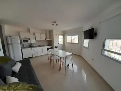 a kitchen and living room with a table and chairs at ALTOS DE VILLA CABRERA in Cordoba