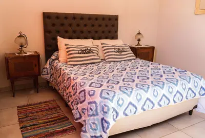 a bedroom with a large bed and two night stands at Bella Vista Casa con pileta y terraza in Villa Carlos Paz