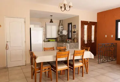 a kitchen and dining room with a table and chairs at Bella Vista Casa con pileta y terraza in Villa Carlos Paz