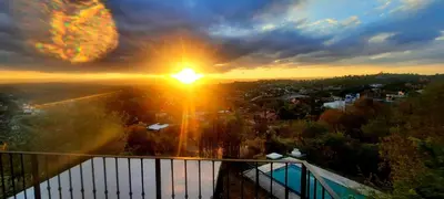 a view of the sunset from the balcony of a building at LA PEDRERA - VILLA DEL LAGO - Carlos Paz - Córdoba - Argentina in Villa Carlos Paz