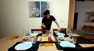 a man standing in front of a table with food at LA PEDRERA - VILLA DEL LAGO - Carlos Paz - Córdoba - Argentina in Villa Carlos Paz
