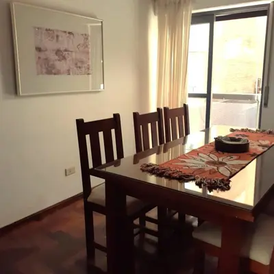 a dining room with a table and chairs and a window at Apartamento Obispo Trejo y Sanabria in Cordoba