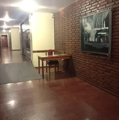 a room with a table and a brick wall at Apartamento Obispo Trejo y Sanabria in Cordoba