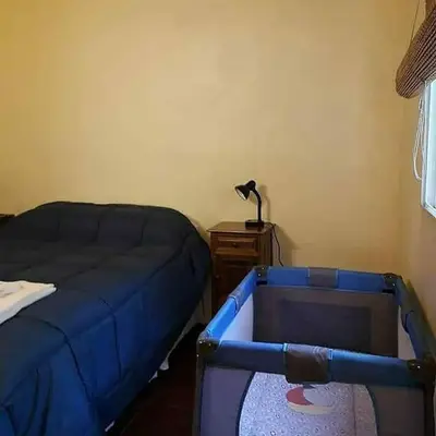 a bedroom with a bed and a table with a lamp at La Serafina in Los Reartes
