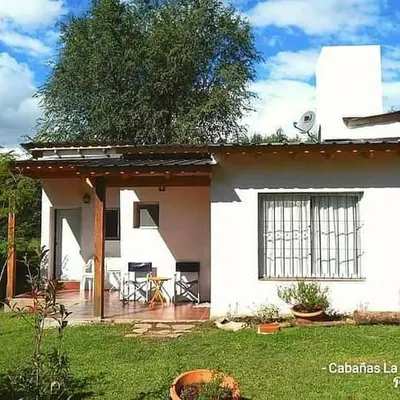 a white house with a porch and a patio at La Serafina in Los Reartes