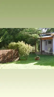 two pictures of a yard with a fence and a house at La Serafina in Los Reartes