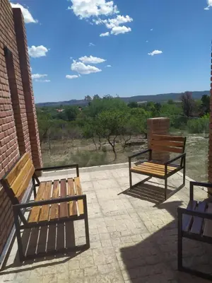 two benches sitting on a patio with a view at Colina del Valle in Mina Clavero