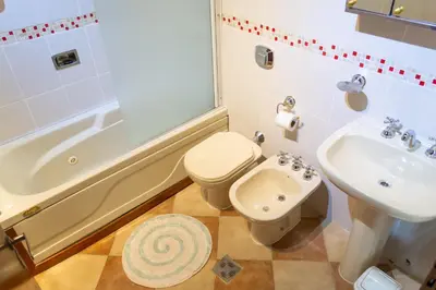 a bathroom with a toilet and a sink and a tub at Colina del Valle in Mina Clavero