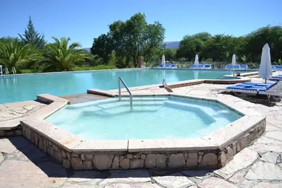 a large swimming pool with a large hot tub at Colina del Valle in Mina Clavero
