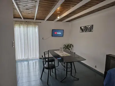 a dining room with a table and chairs and a tv at La Margarita Lofts - Solo 2 Adultos in Mina Clavero