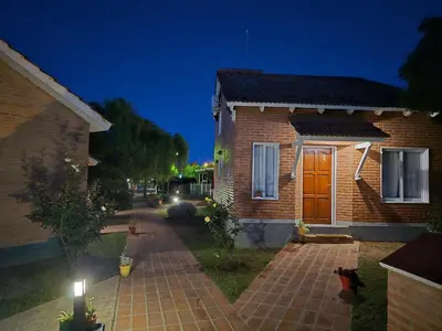a brick house with a brick walkway in front of it at La Margarita Lofts - Solo 2 Adultos in Mina Clavero