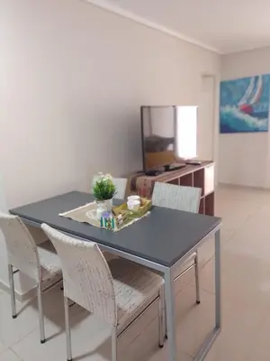 a dining room table with chairs and a blue table at Departamento en Nueva Córdoba - Patagonia 7 in Cordoba