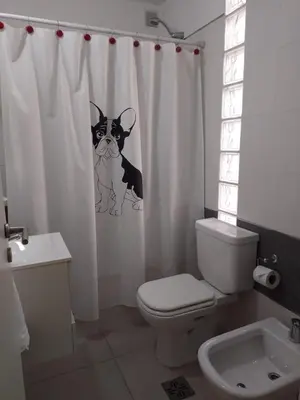 a bathroom with a shower curtain with a dog on it at Departamento en Nueva Córdoba - Patagonia 7 in Cordoba