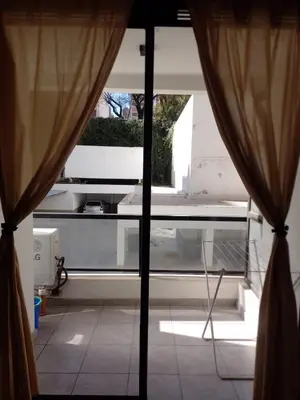 a view of a room with a window with curtains at Departamento en Nueva Córdoba - Patagonia 7 in Cordoba